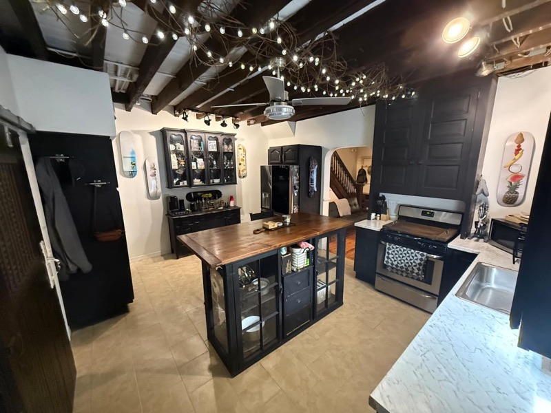 Open living room and kitchen with exposed dark beams